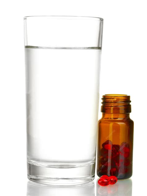 Premium Photo | A glass of water and pills isolated on white closeup