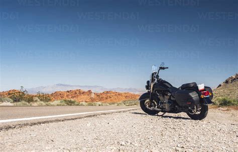 Motorcycle Parked By Desert Road Against Clear Blue Sky Nevada USA