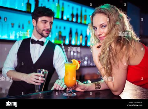 Woman Leaning On Counter While Bartender In Background Stock Photo Alamy