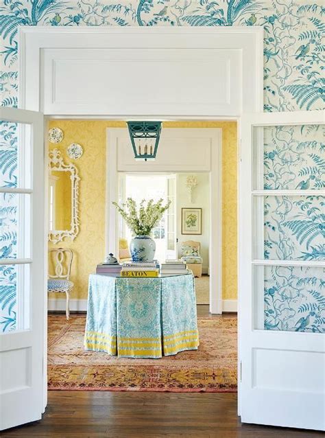 A Charming Turquoise Blue And Yellow Foyer Boasts Walls Clad In Yellow