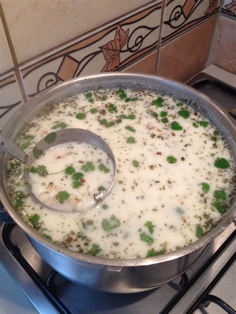 A Pot Filled With Soup Sitting On Top Of A Stove