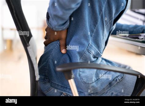 Back Pain Bad Posture Man Sitting Stock Photo - Alamy