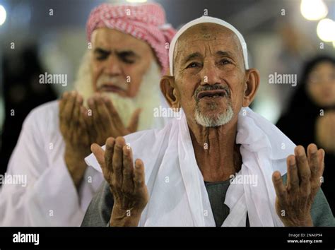 Muslim Pilgrims Pray After Casting Stones At A Pillar Symbolizing The