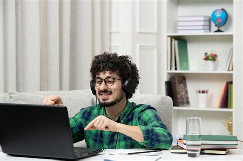 Premium Photo | Student online cute young guy studying on computer in glasses in green shirt ...