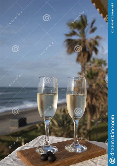 Glasses Of Spanish Cava Sparkling Wine And View On Blue Sea And Sandy Beach Costa Del Sol