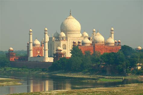 taj mahal stands   calm river photo  building image