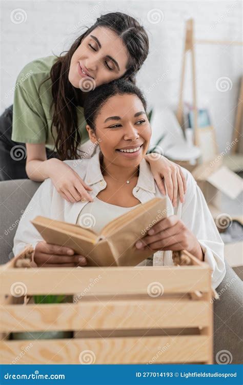 Cheerful Lesbian Woman Hugging Multiracial Girlfriend Stock Image