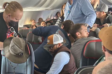 Man Tries To Open Emergency Exit Mid Flight Passengers Restrain Him