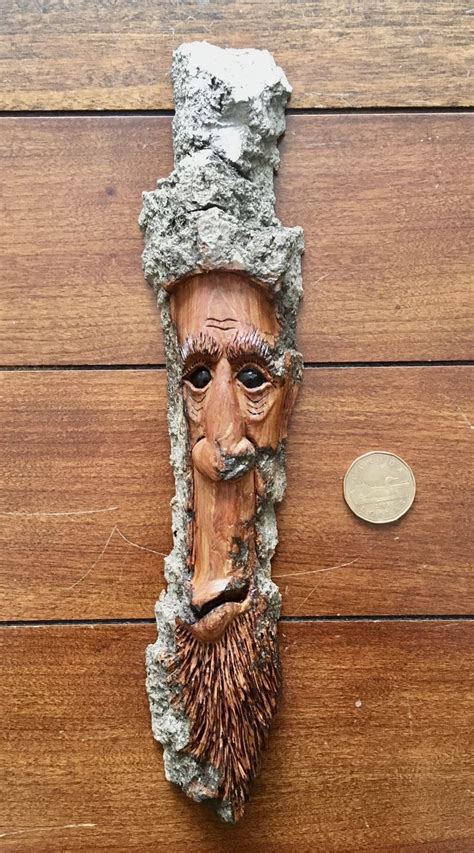 A Wooden Carving Of A Mans Head With A Beard And Moustache