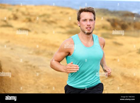 Man Running Outdoors In Nature Fit Male Runner Jogging Outside