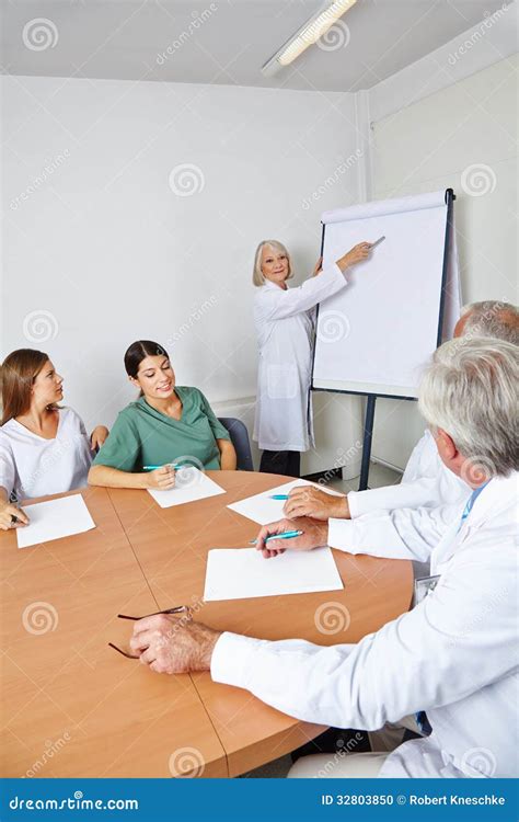 Doctor Giving Lecture At Team Meeting Stock Photo Image Of Space