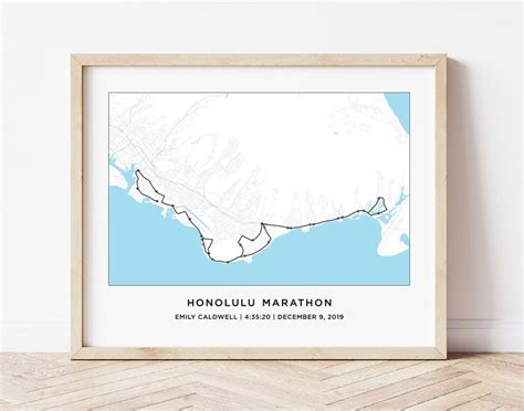 a framed map of honolulu marathon in blue and white on a wooden floor ...