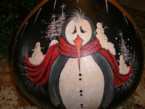 A Painted Egg With A Snowman And Penguins On It