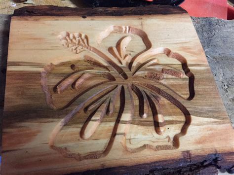 Hibiscus Carving Into Poplar Wood Stained With Bark On Edges Rustic