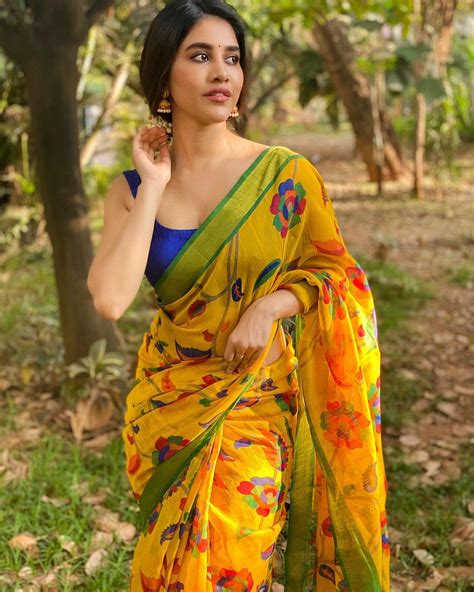 Nabha Natesh Photoshoot in Sleeveless Blouse and Yellow Saree