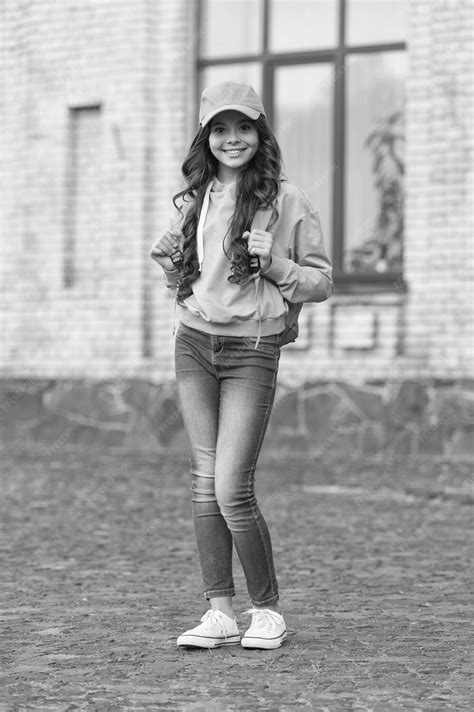 Premium Photo | Redefining childhood learning happy child carry backpack outdoors childhood ...