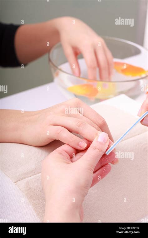 Beautician With File Filing Nails Female Client Woman Spa Beauty Salon