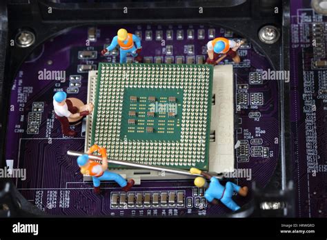 Selective Focus Of Miniature Engineer And Worker Repair Cpu Processor