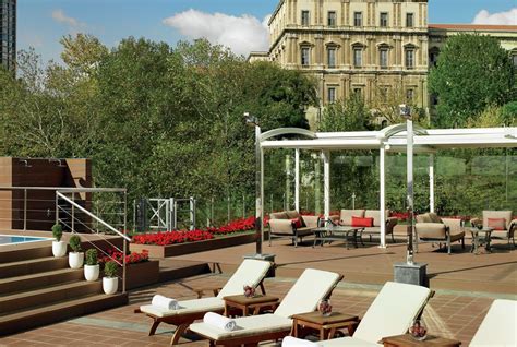 Lounge Chairs And Umbrellas On The Roof Of A Building