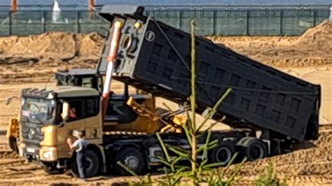 A Dump Truck Brought Sand To The Construction Site And Unloaded It