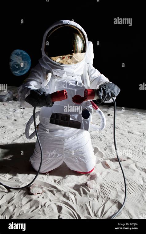 An Astronaut On The Moon Connecting Two Cables Stock Photo Alamy