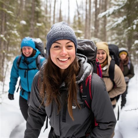 Premium Photo A Group Of Hikers Smiling As They Trek Through A Snowy