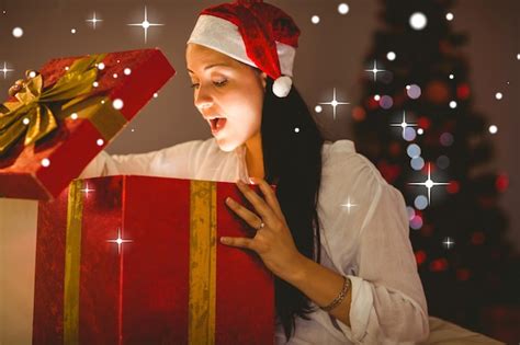 Premium Photo Composite Image Of Festive Brunette Opening A Glowing