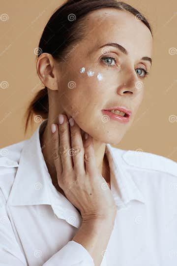 Modern 40 Years Old Woman In White Shirt Isolated On Beige Stock Image