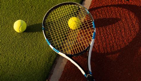 Tennis Balls And Racket On The Green Grass Background Stock Image