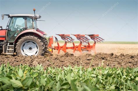 Tractor plowing Stock Photo by ©fotokostic 78284840