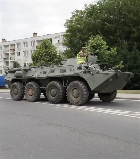 An Army Vehicle Driving Down The Street