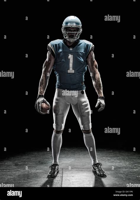 Football player holding ball Stock Photo - Alamy