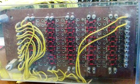 Examining the core memory module inside a vintage IBM 1401 mainframe