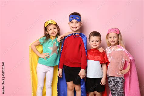 Cute children in superhero costumes on color background Stock Photo ...