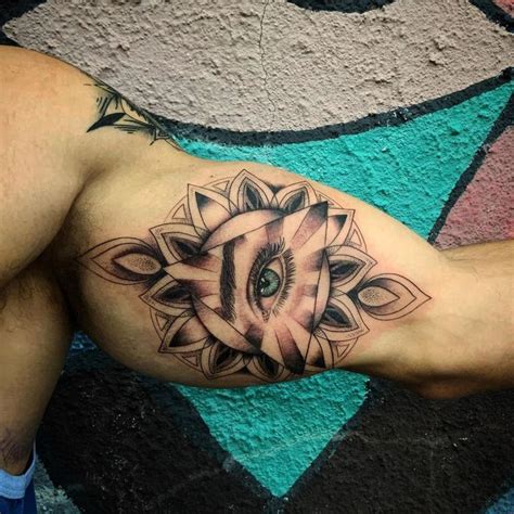 A Man With A Tattoo On His Arm Has An Elephants Eye In The Center