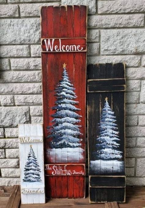 Two Wooden Signs With Christmas Trees Painted On Them One Is Welcome