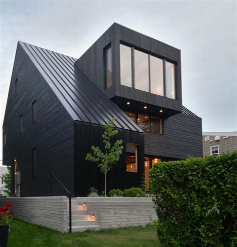 The Black Roof, Siding, And Window Frames On This Home Combine To Make ...