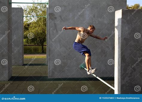 The Guy Performs A Jump On The Site For Practicing Parkour Editorial