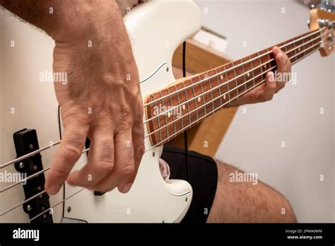 White Electric Bass In Musical Solo Showing In Detail The Beating Of