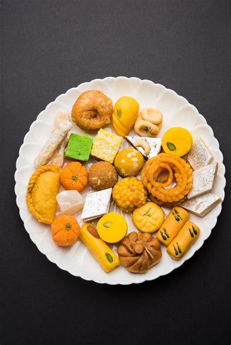 Indian Sweets Or Mithai For Diwali Festival With Oil Lamp Or Diya And