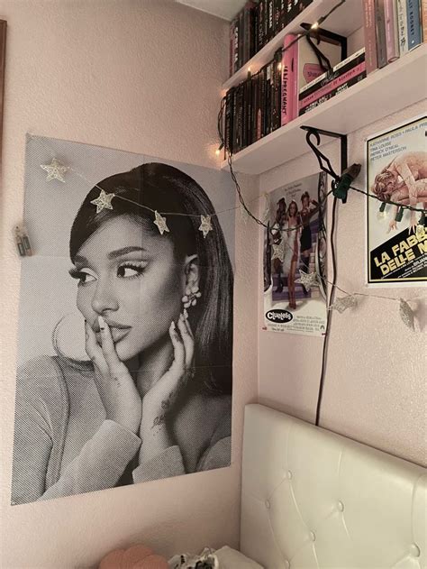 A Bedroom With Pink Walls And Pictures On The Wall Including A White