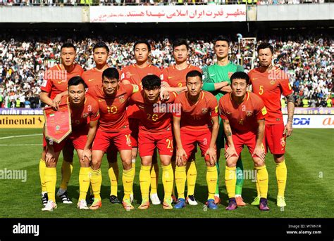 Players of the starting line-up of Chinese national football team pose ...