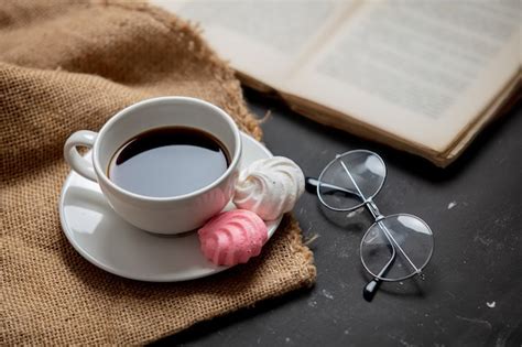 Premium Photo Cup Of Black Coffee And Book With Glasses