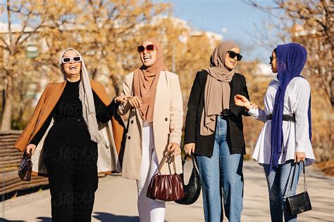 Cheerful Muslim Women In Hijab Having A Walk And Talking To Each Other