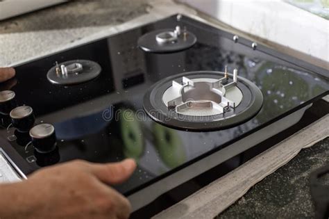 A Man Installs a Built-in Glass-ceramic Gas Stove on a Kitchen ...