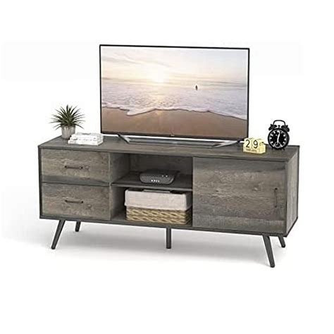 an entertainment center with a flat screen tv on it's stand and two drawers