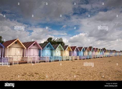 Row Of Pastel Painted Beach Huts Mersea Island Essex Uk Stock Photo