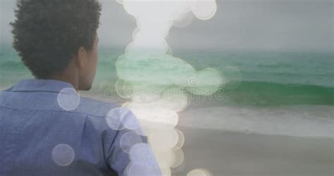 Image Of Light Spots Over Disabled African American Man Sitting In