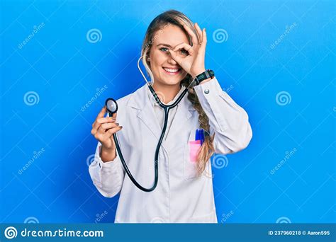 Beautiful Young Blonde Doctor Woman Holding Stethoscope Doing Ok