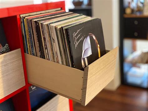 A Wooden Shelf Holding Various Records And Cds